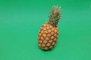 ananas on green background photo