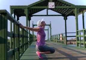 woman  stretching before morning jogging photo