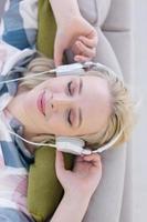 girl enjoying music through headphones photo