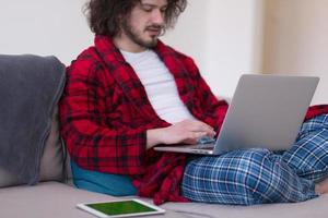 man freelancer in bathrobe working from home photo