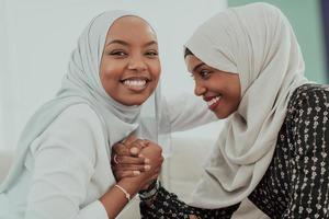 African woman arm wrestling conflict concept, disagreement and confrontation wearing traditional islamic hijab clothes. Selective focus photo