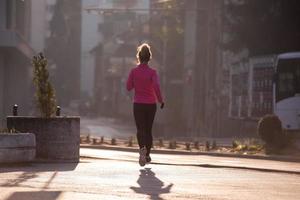 sporty woman jogging on morning photo