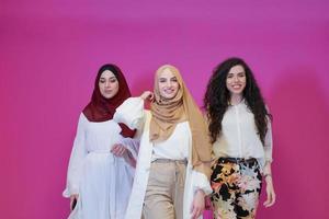 muslim women in fashionable dress isolated on pink photo