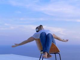 relaxed young man at home on balcony photo