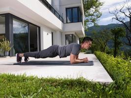 man doing morning yoga exercises photo