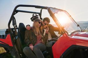 couple enjoying beautiful sunny day while driving a off road buggy photo