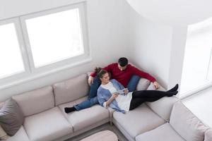 couple relaxing at  home with tablet computers photo