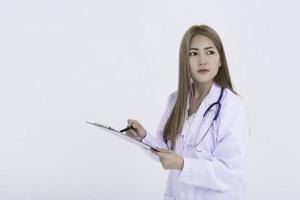 Portrait of young doctor working on white background photo