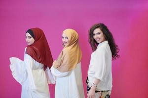 muslim women in fashionable dress isolated on pink photo