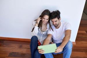 couple at modern home using tablet computer photo