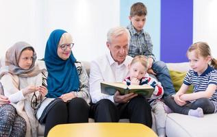 modern muslim grandparents with grandchildren reading Quran photo