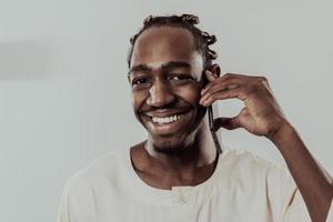 African man using smartphone and wearing traditional Sudan clothes. photo