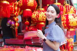 Asian beautiful woman in long hair wears a grey Chinese dress with Chinese new year theme. photo