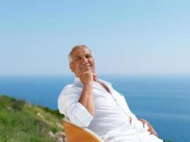 senior man sitting outside photo