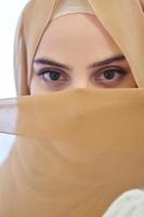 Portrait of young girl with niqab on face photo