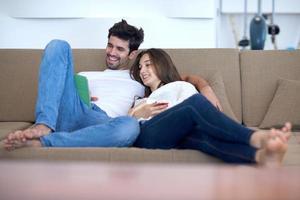 couple at modern home using tablet computer photo