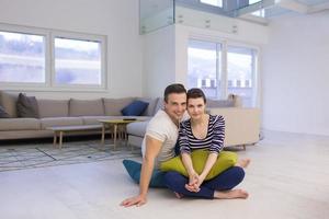 couple sitting on the floor at home photo