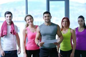 Group of people exercising at the gym photo