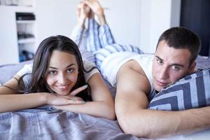 couple relax and have fun in bed photo