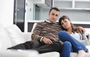 Relaxed young  couple watching tv at home photo