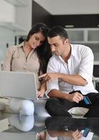 joyful couple relax and work on laptop computer at modern home photo