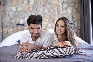 couple relax and have fun in bed photo