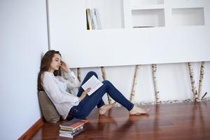 relaxed young woman at home working on laptop computer photo