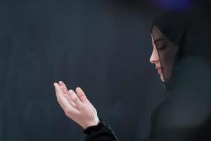 Portrait of young Muslim woman making dua photo