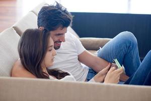 couple at modern home using tablet computer photo