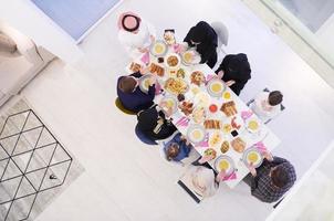 traditional muslim family praying before iftar dinner top view photo