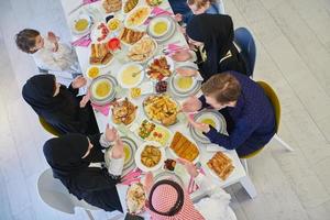 Top view of Muslim family making iftar dua to break fasting during Ramadan. photo