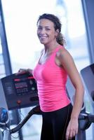 woman exercising on treadmill in gym photo