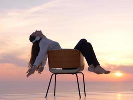 mujer joven disfruta de la puesta de sol foto