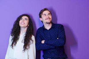 portrait of young couple isolated over purple background photo