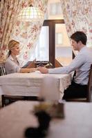 young couple having dinner at a restaurant photo