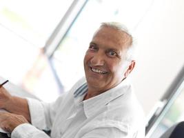 Portrait of senior man relaxing in sofa photo