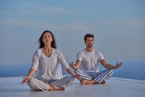 young couple practicing yoga photo