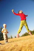 Kid jumping outside photo