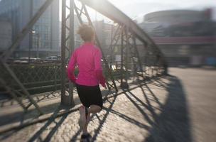 sporty woman jogging on morning photo