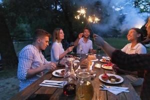 friends having picnic french dinner party outdoor during summer holiday photo