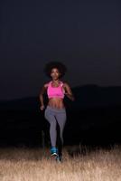 Young African american woman jogging in nature photo