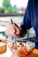 man eating healthy food it an restaurant photo