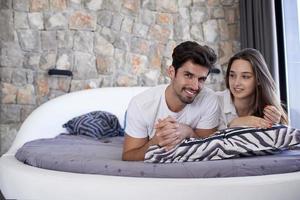 couple relax and have fun in bed photo