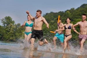 group of happy friends having fun on river photo