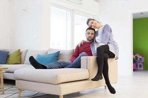 couple hugging and relaxing on sofa photo