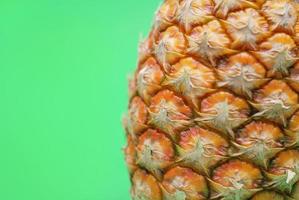 ananas on green background photo