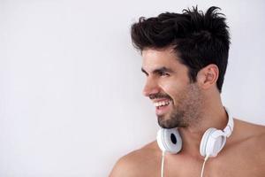 handsome young man listening music on headphones photo