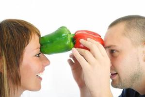 happy couple holding peppers with head photo