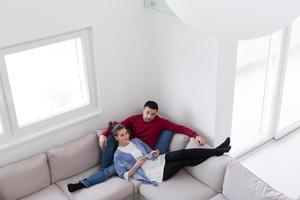 couple relaxing at  home with tablet computers photo