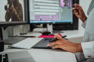 Young Afro-American modern Muslim businesswoman wearing a scarf in a creative bright office workplace with a big screen. photo